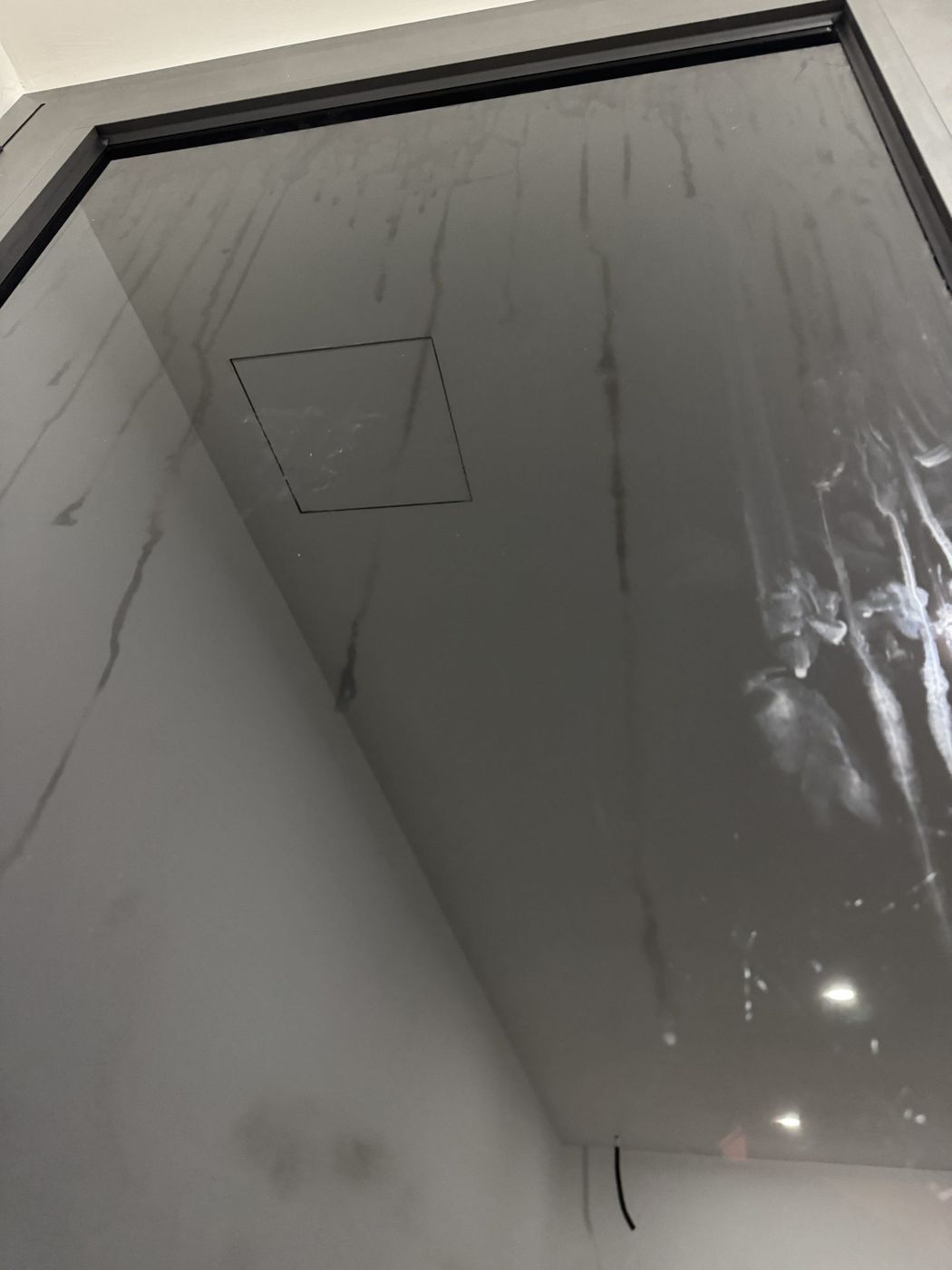 El mismo panel de cristal antes, con regueros de cal secos